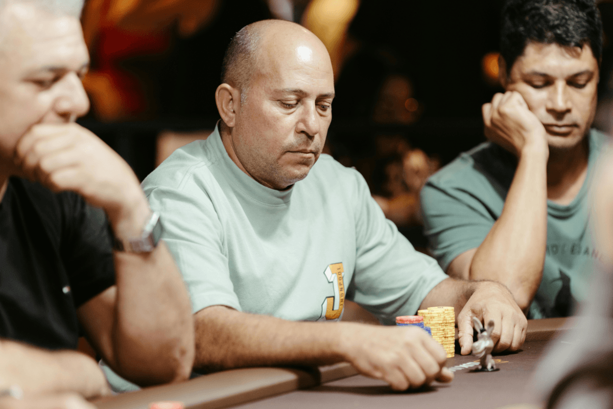 A poker table with chips and cards under warm lighting